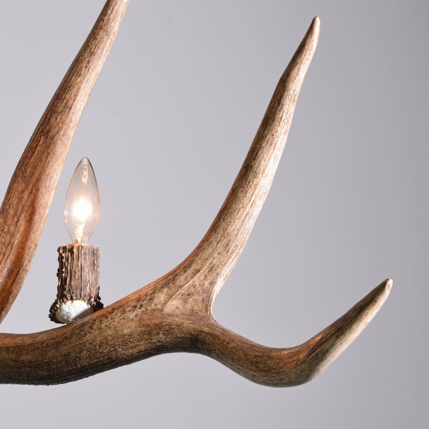 A close up of the huge elk antlers and exclusive light cup design used to make the Grand Teton Antler Chandelier.